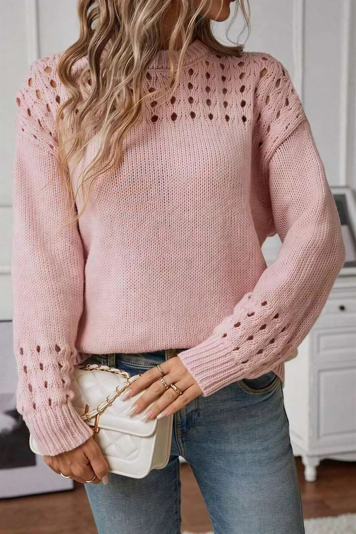 Pink striktrøje med åben stingdetalje set forfra